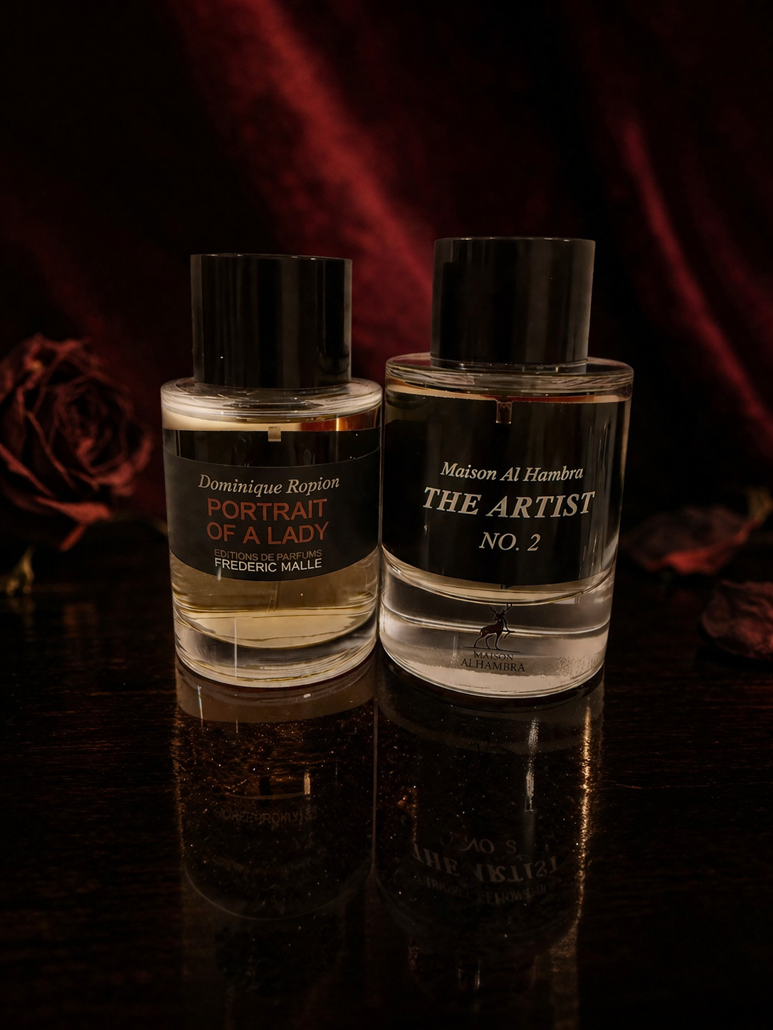 Frederic Malle Portrait of a Lady alongside its clone Maison Al Hambra The Artist No. 2, both bottles on a dark mahogany surface with burgundy velvet background and dried dark rose