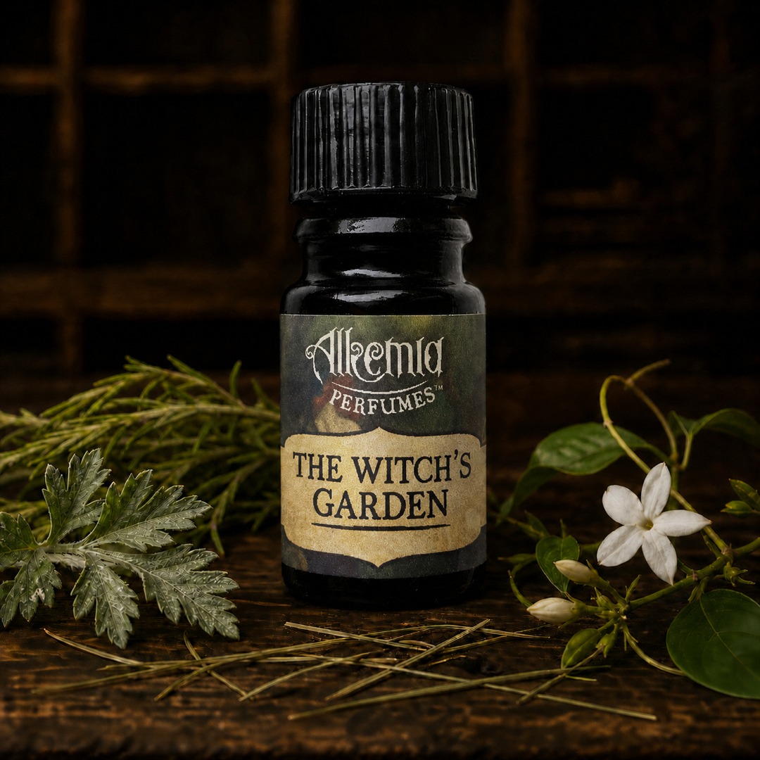Alkemia Perfumes The Witch's Garden bottle beside garden botanicals