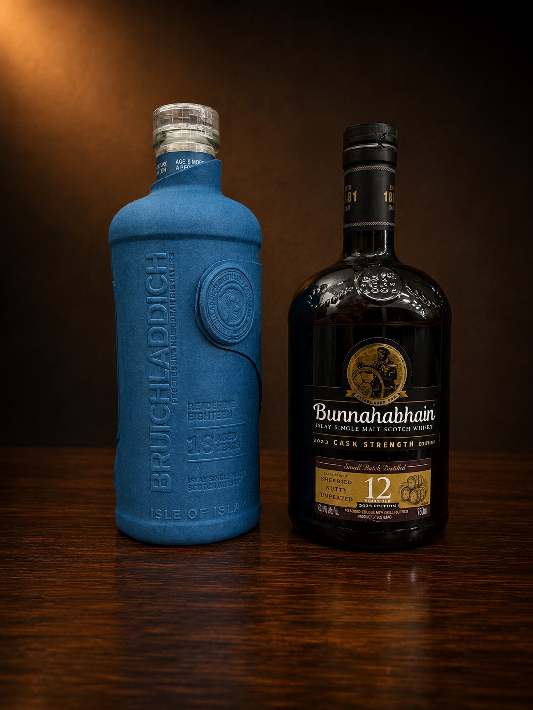 Bunnahabhain Cask Strength and Bruichladdich 18 whisky bottles side by side on a shelf